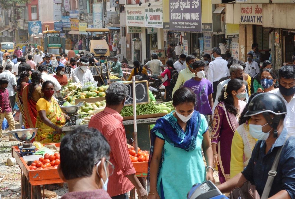 Bengaluru : People shopping vegetables and fruits at Avenue Road, after the Karnataka government eased restrictions amid ongoing Coronavirus lockdown, in Bengaluru on Tuesday, June 22, 2021 (Photo: IANS)